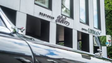 A modern building with a sign for 'Restoran W. Lydian' and 'Hotel Lydian'.