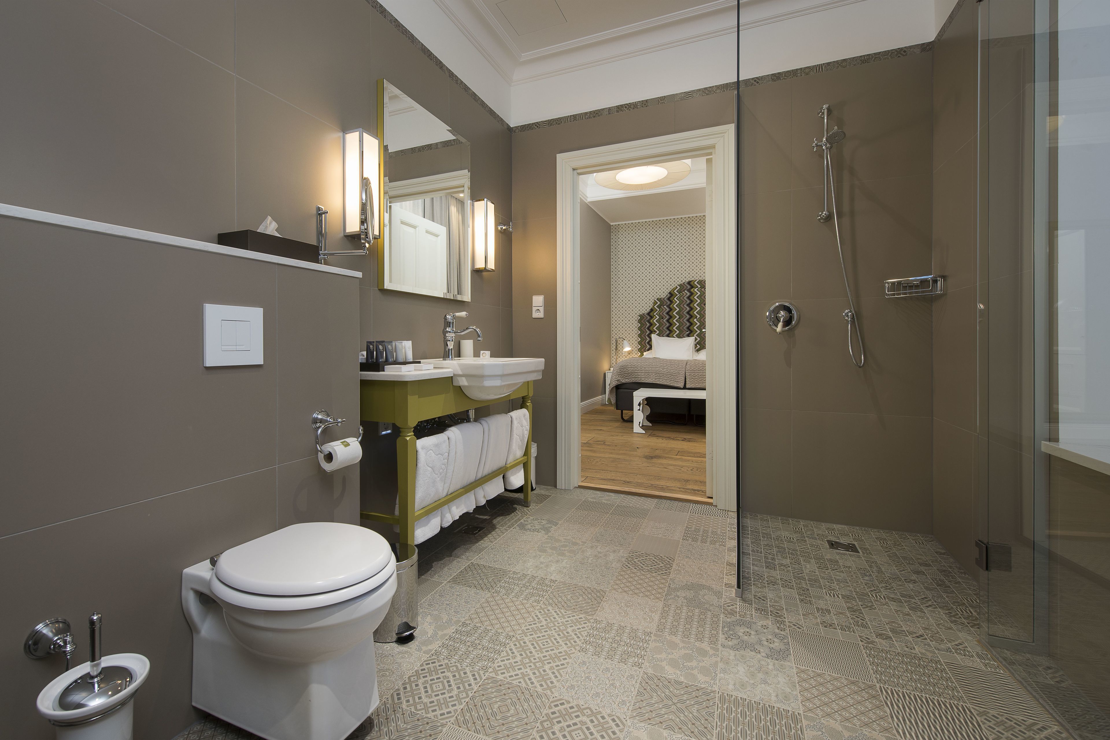 A modern bathroom with a toilet, sink, and shower.