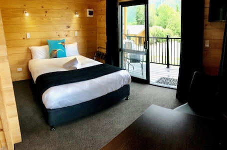 Premium Cabin | 1 bedroom, down comforters, in-room safe, iron/ironing board