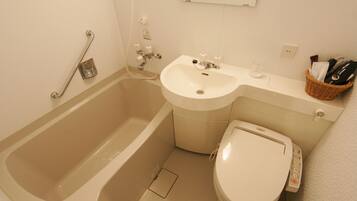 A bathroom with a bathtub, a sink, and a toilet.