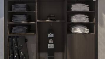 A storage closet with shelves for folded clothes, a shoe rack, and a black stand with a label.