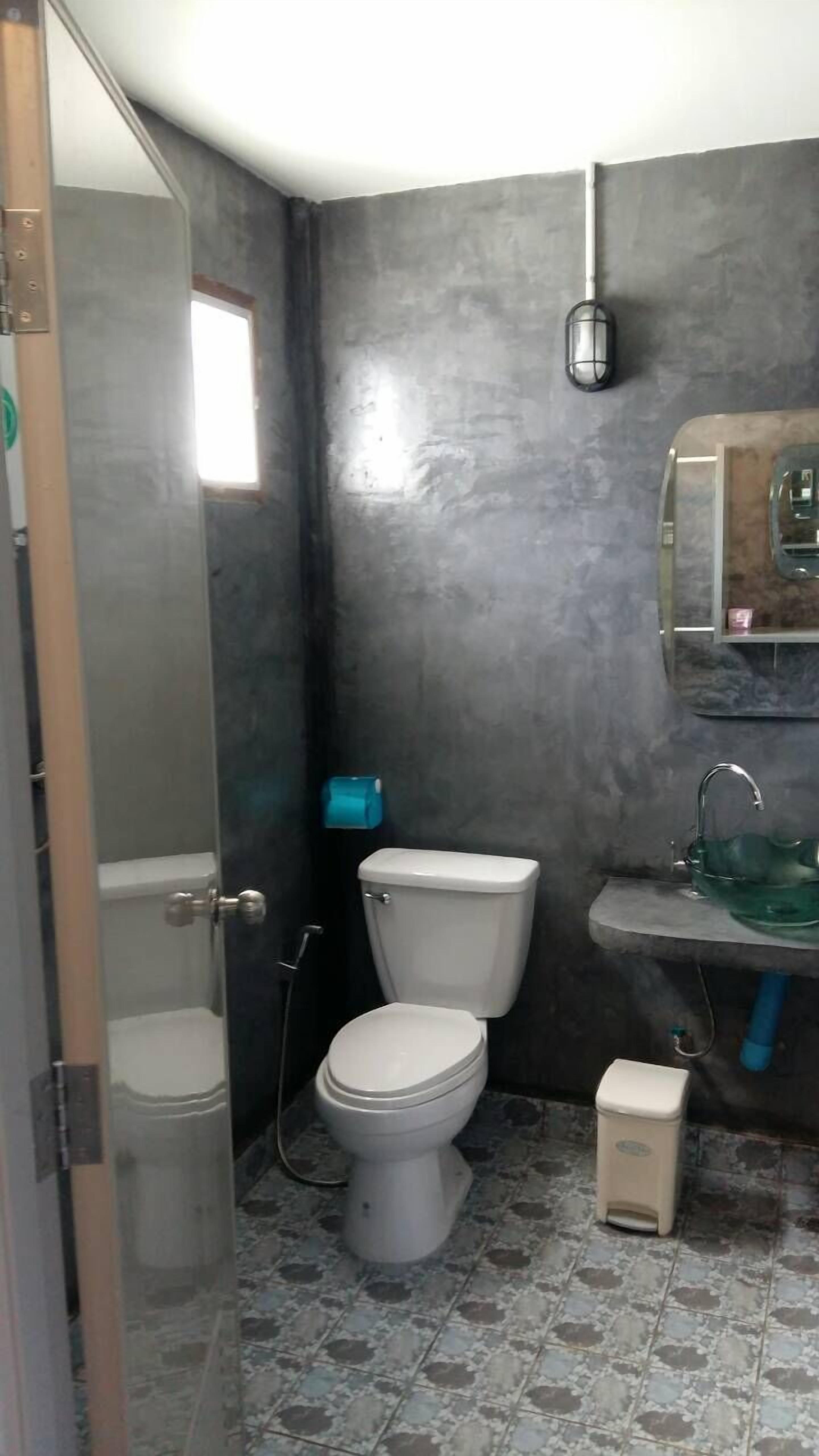 A bathroom with a toilet, a sink, and a shower.