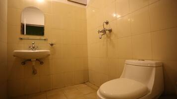 A bathroom with a sink, mirror, and toilet.