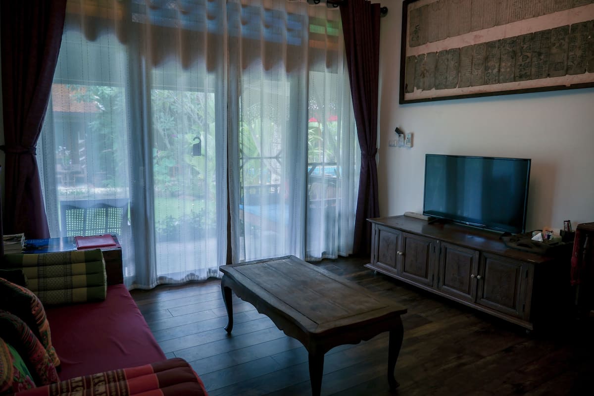 luxury double room, 1 king bed, bathtub, pool view | living area | 46-inch flat-screen tv with cable channels, tv