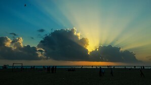 A beach with people and a goalpost. - Baywatch Beach Resort (Ambalapuzha)