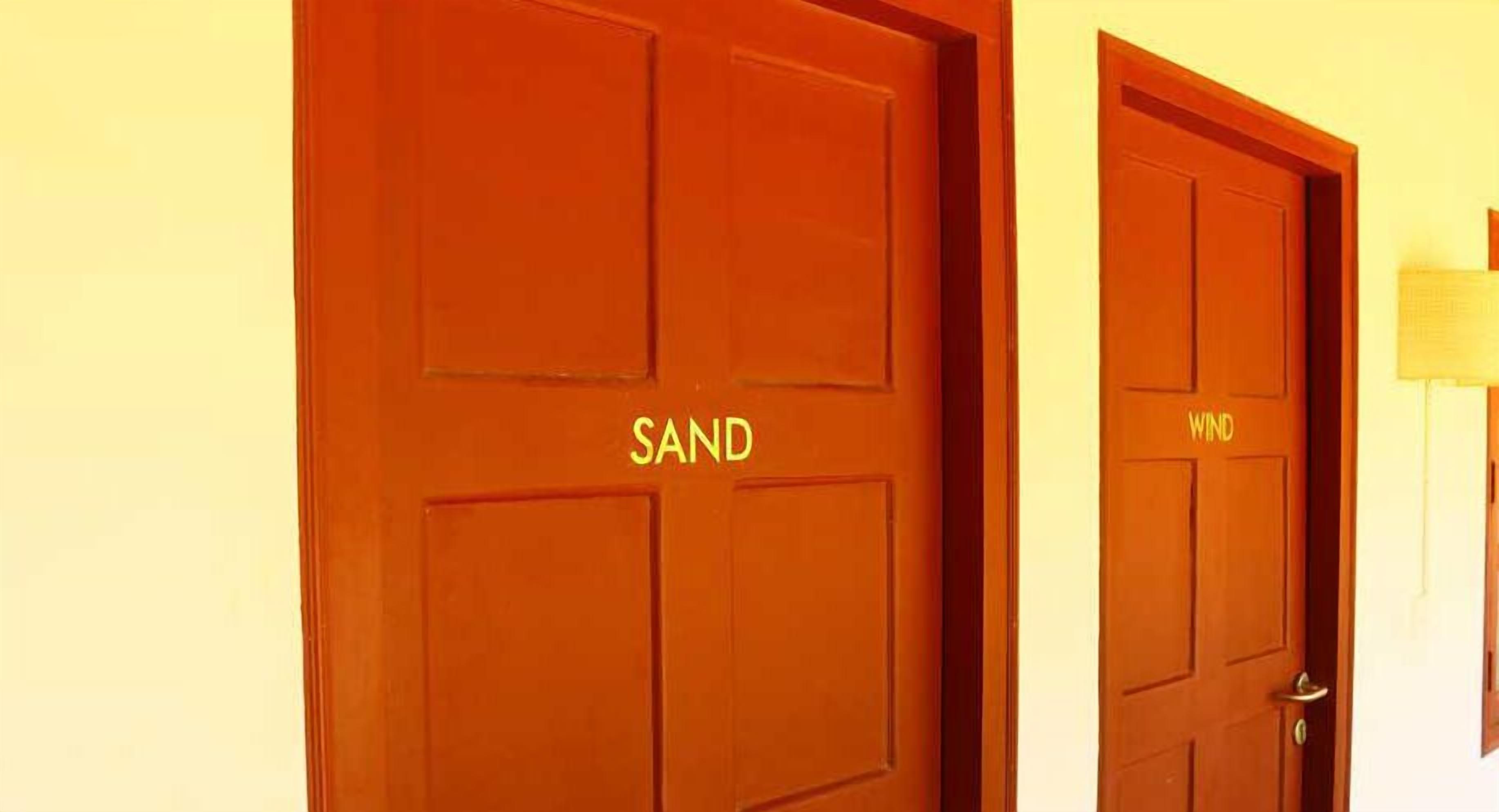 Two wooden doors with the words "SAND" and "WIND" on them.