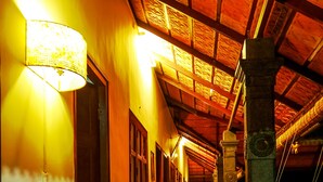A corridor with wooden flooring and a high ceiling with exposed beams. - Baywatch Beach Resort (Ambalapuzha)