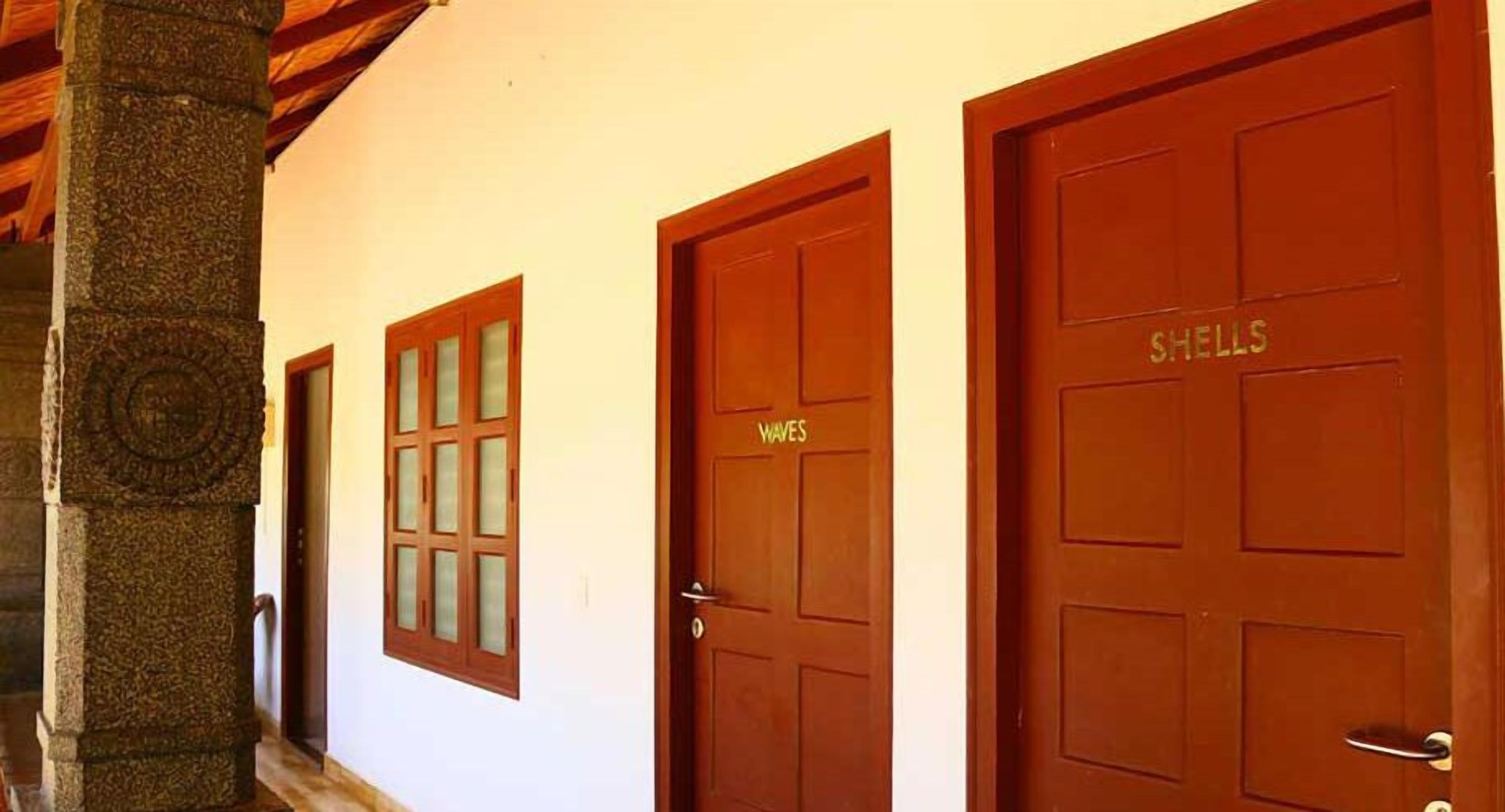 A hallway with three doors labeled "Waves," "Shells," and "Waves."