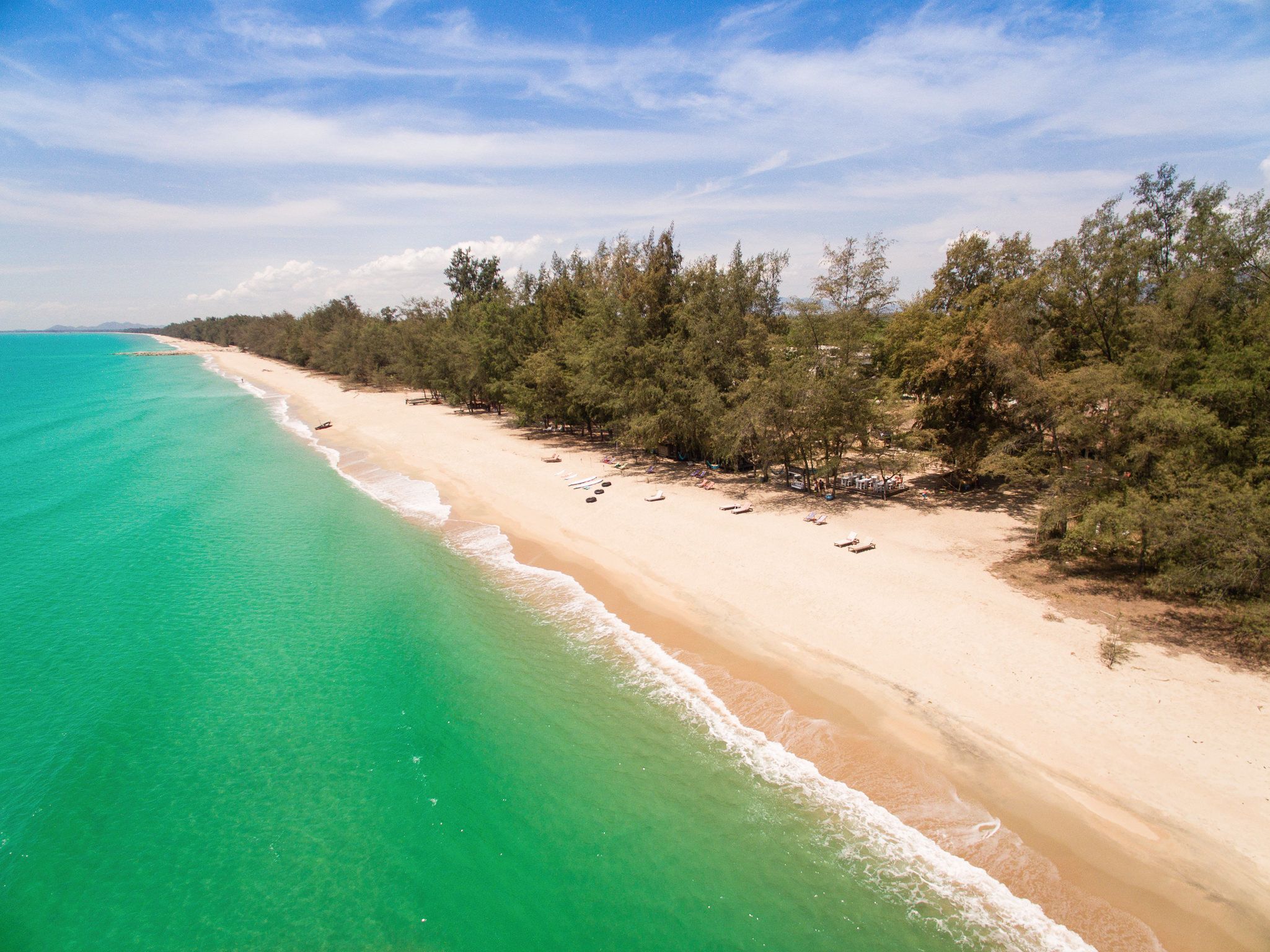 On the beach, sun-loungers, beach towels, surfing