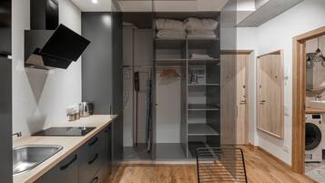 A modern kitchen with a built-in stove, a sink, and a wooden countertop.
