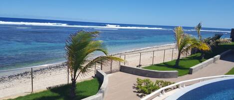 A resort with a pool, a beach, and ocean views.