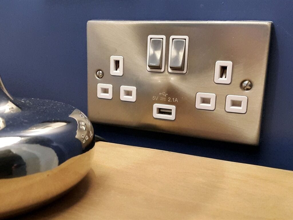 A wall-mounted electrical outlet with multiple switches and sockets, including a USB port.