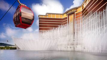 A water fountain feature in front of a building with a clear sky.