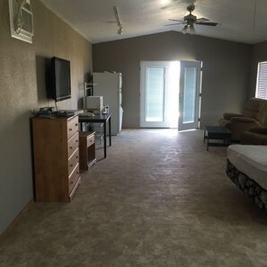 Deluxe Room 1 (in shared house) | Living area | Flat-screen TV