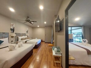 A hotel room with two beds, a ceiling fan, a TV, and a view of the outdoors. - Khong Chiam Orchid Riverside Resort (Khong Chiam)