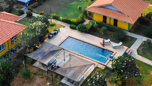 A resort with a swimming pool, outdoor seating, and a view of a lake. - Khong Chiam Orchid Riverside Resort (Khong Chiam)
