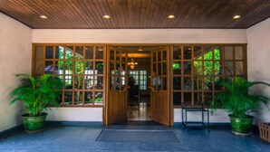 A wooden ceiling, a glass door entrance, and potted plants. - Sakura Residence (Yangon)