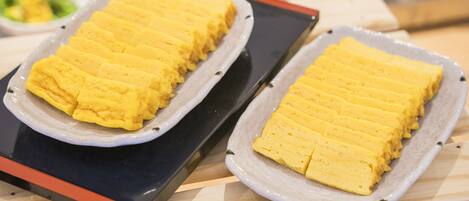 Two rectangular trays of yellow food items on a table.