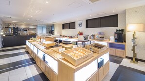 A modern hotel breakfast area with a checkered floor, wooden counter, and various breakfast items displayed. - Centurion Hotel Grand Kobe Station (Kobe)
