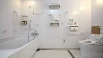 A modern bathroom with a bathtub, toilet, and shower area.