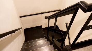 A staircase with black handrails and wooden steps.