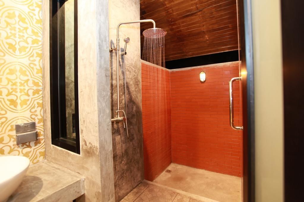 A bathroom with a shower, a sink, and a toilet.