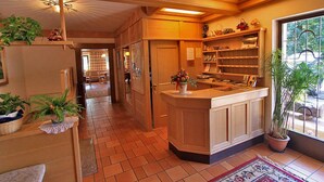 A spacious kitchen with wooden cabinets, a central island, and a large window providing natural light.