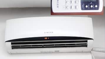 A white air conditioning unit with a digital display and control panel.