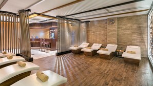 A spa area with wooden flooring, massage tables, and a reception desk. - B Business Hotel & Spa (Antalya)