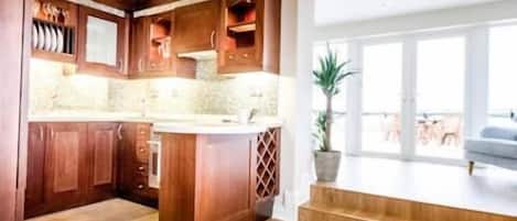 A modern kitchen with wooden cabinets and a central island.