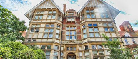 A large, symmetrical building with a central entrance and multiple windows.