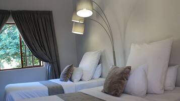 Standard Twin Room | In-room safe, individually decorated, desk, blackout drapes