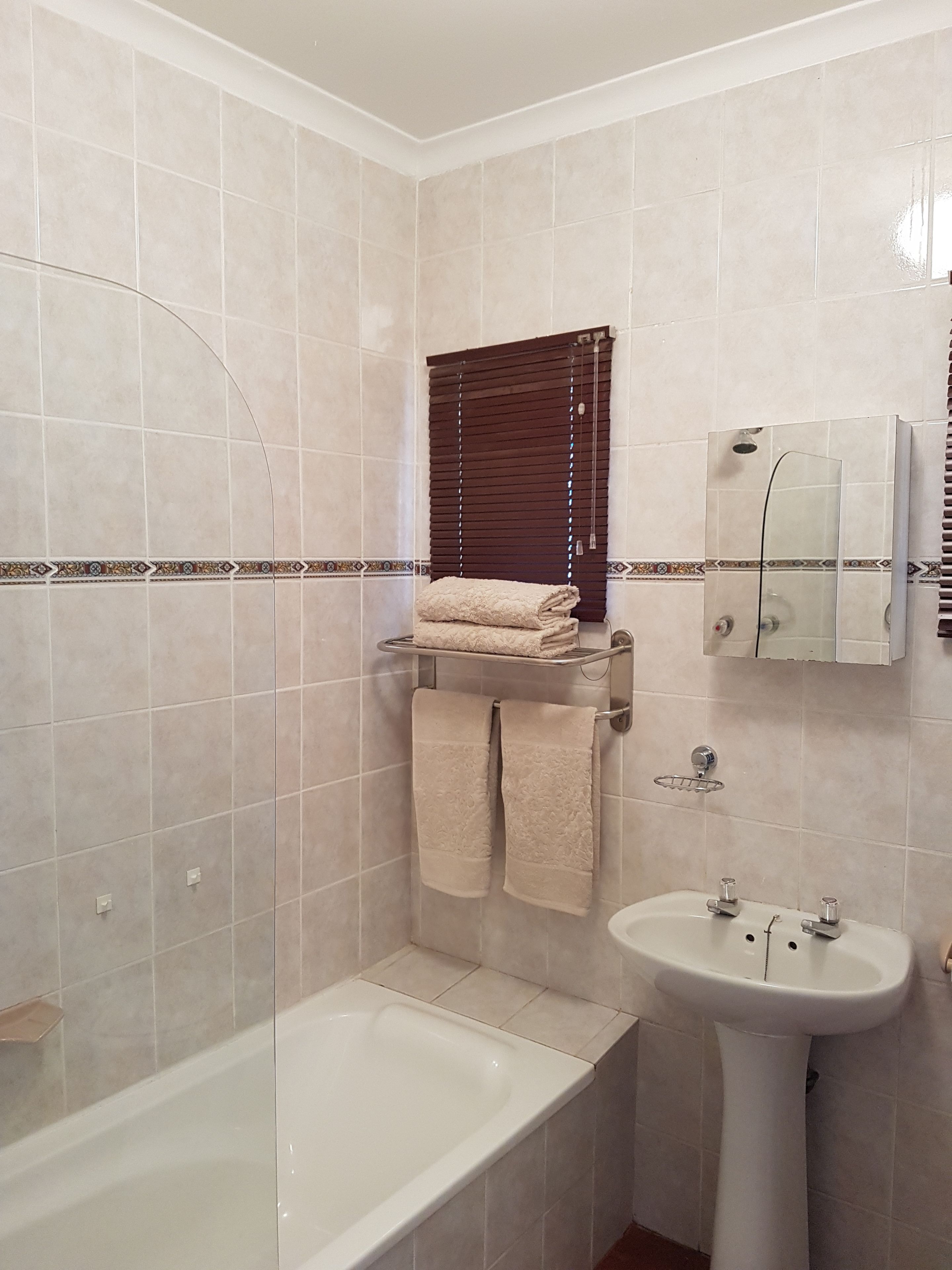 A bathroom with a bathtub, a sink, and a shower.