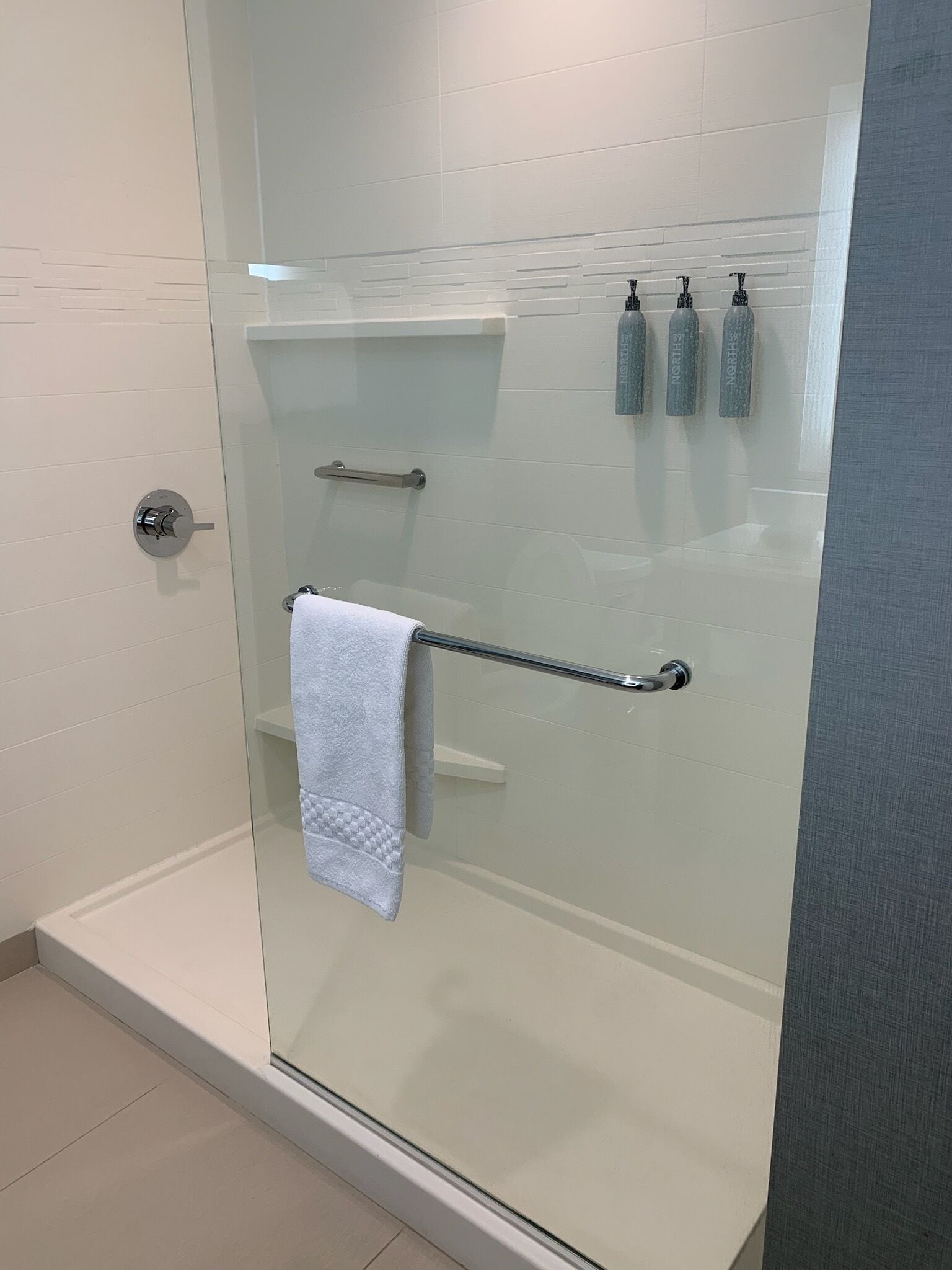 designer toiletries, hair dryer, towels, soap