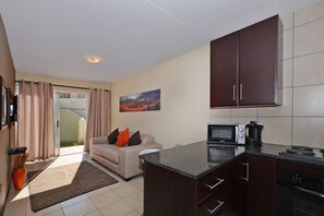 Apartment (One A) | Living room | 32-inch flat-screen TV with digital channels, TV - Jozi Apartments Radiokop (Roodepoort)