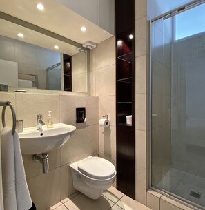 Superior Studio | Bathroom | Rainfall showerhead, hair dryer, towels, soap