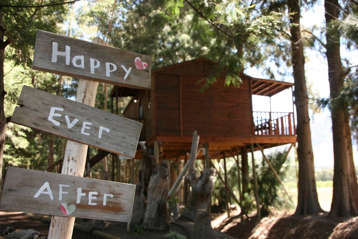 A wooden sign with the words "Happy Ever After" and a small heart symbol.
