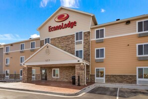 A hotel with a prominent EconoLodge sign, a covered entrance, and a stone facade. - Econo Lodge Burlington I-70 (Burlington)