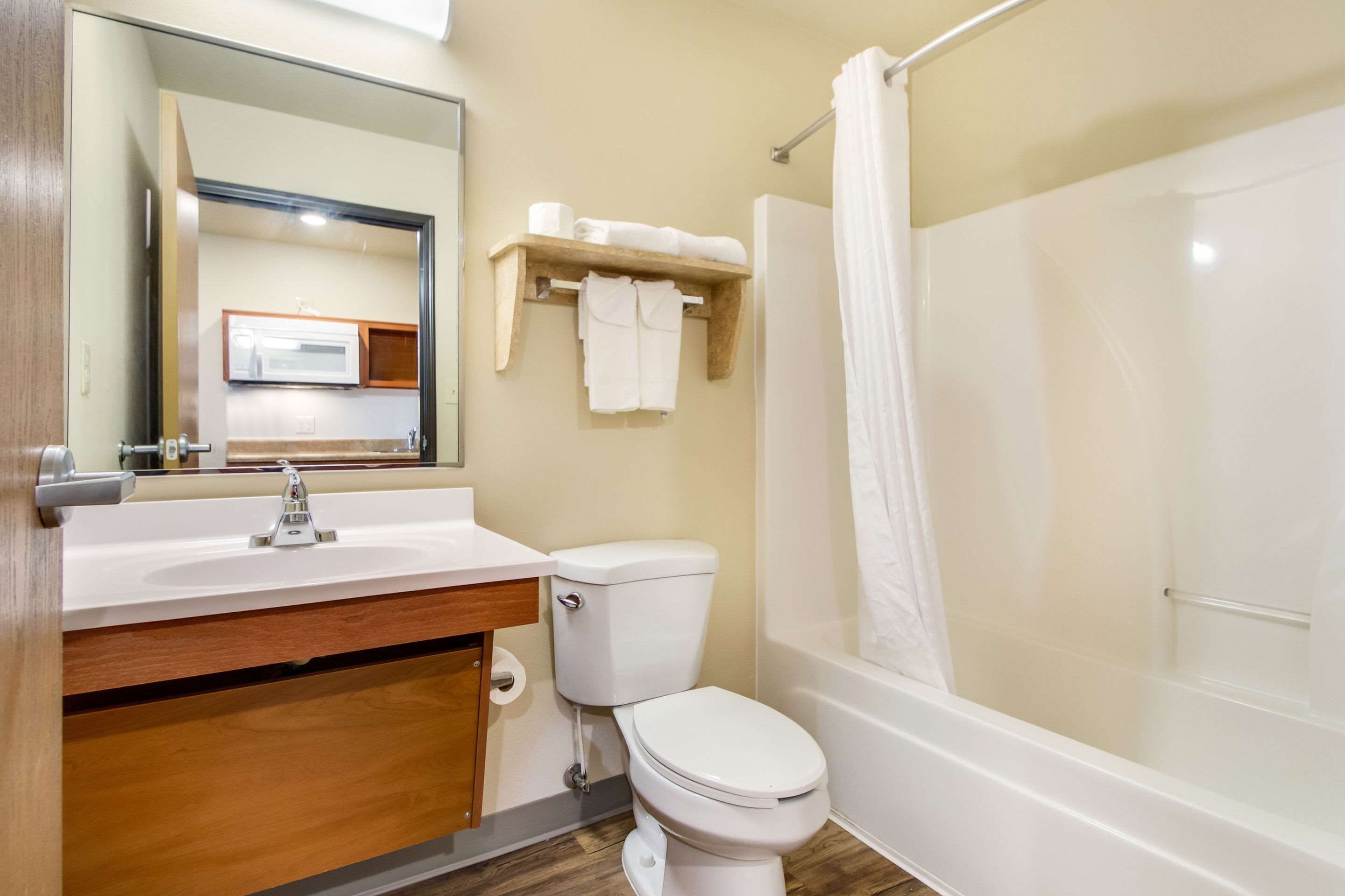 A bathroom with a sink, toilet, and shower.