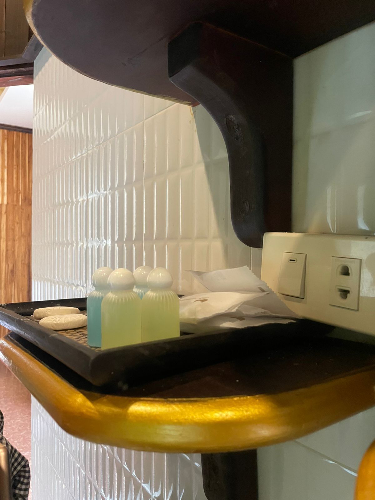 A kitchen counter with a tray holding bottles and a white towel.