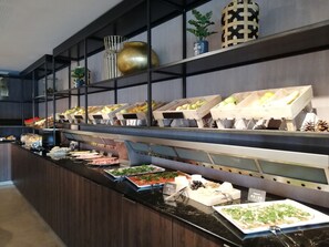 A buffet setup with various food items and decorative elements. - Van Der Valk Hotel Oostzaan - Amsterdam (Oostzaan)