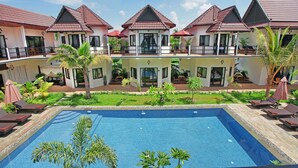 A hotel with a swimming pool, multiple balconies, and lush greenery. - SR Sofia Villa Hotel (Siem Reap)