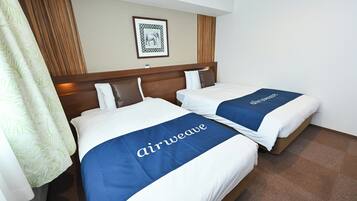 Two beds with 'airweave' branded bedspreads, a framed picture on the wall, and a wooden headboard.