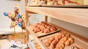 A bakery display with various baked goods. - La'gent Hotel Osaka Bay (Osaka)