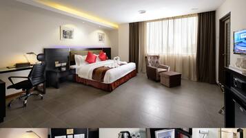 A hotel room with a bed, desk, chair, TV, and a minibar.