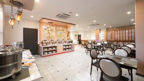 A buffet area with multiple serving stations, a central display case, and a seating area with tables and chairs. - E-Red Hotel Sdn Bhd (Kuantan)