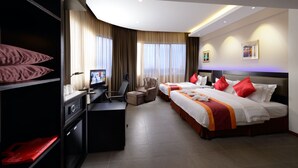 A hotel room with a bed, desk, chair, and TV. - E-Red Hotel Sdn Bhd (Kuantan)