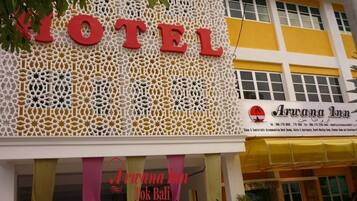 A hotel sign with a geometric pattern and the name "HOTEL" in large letters.
