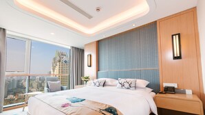 A modern hotel room with a large bed, a nightstand, a chair, and a city view. - Nade Hotel (Hangzhou)