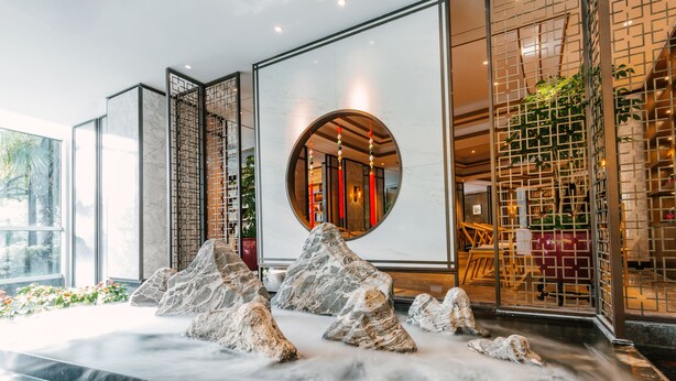 A spa area with a water feature and a large mirror reflecting the interior. - Nade Hotel (Hangzhou)